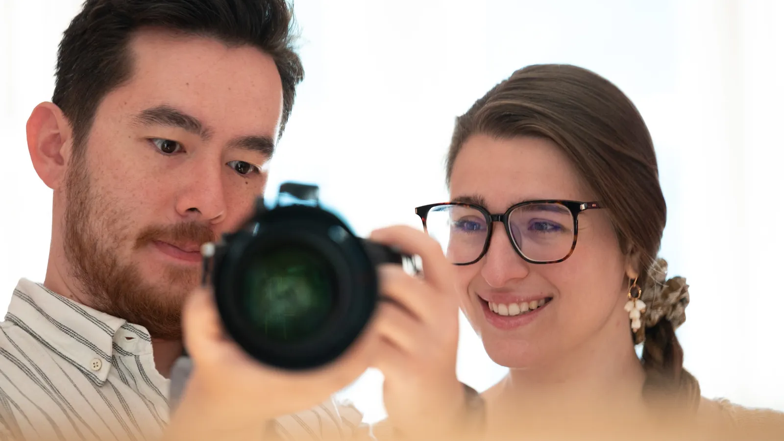 Two photographers reviewing a shot together on camera
